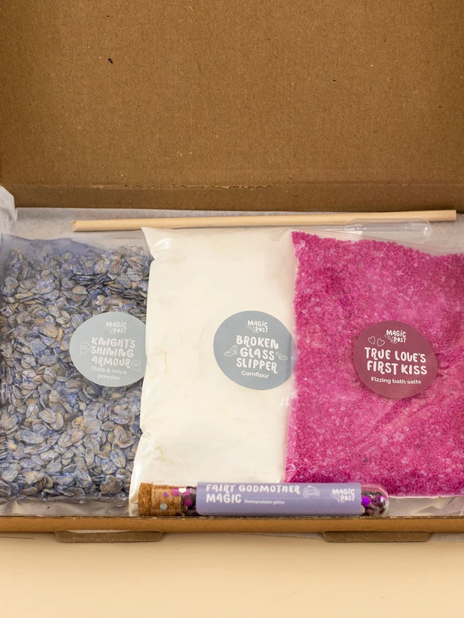 princess mini sensory potion kit. three bags of assorted sensory materials placed into a cardboard box.