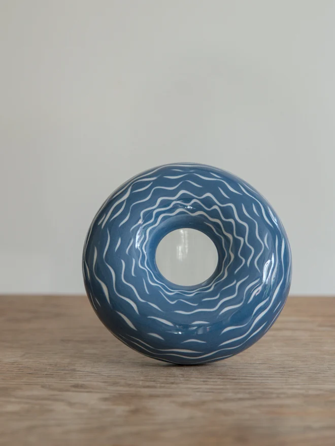 Handmade porcelain avocado planter with carved blue pattern, designed to hold an avocado seed for sprouting