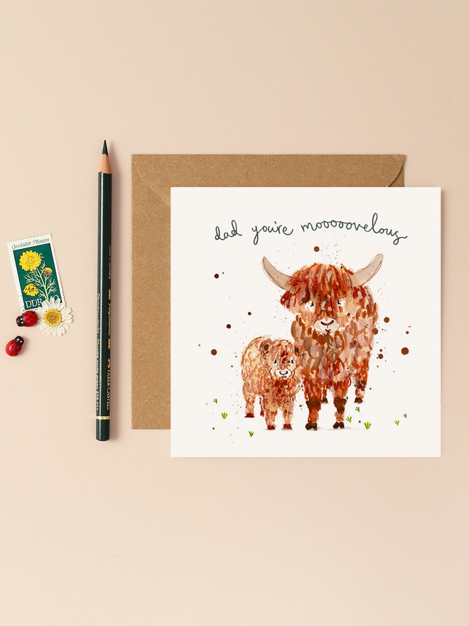 A whimsical illustration of a father and child Highland cow standing side by side. The father cow, with its distinctive long, wavy fur and horns, lovingly nuzzles the smaller calf. Above them, the playful message "Dad you're mooooovelous" is handwritten in a charming, flowing script. The design combines earthy tones and soft textures, capturing the warmth and affection of the duo.