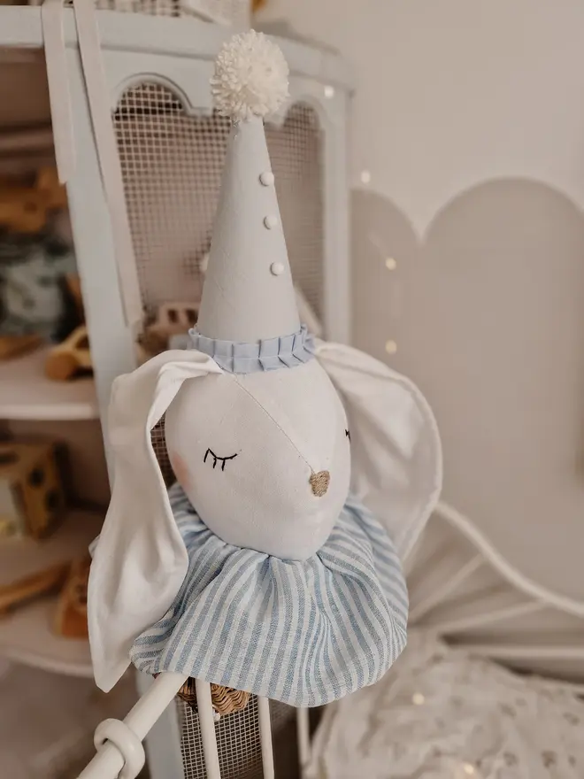 Rabbit Head Wall Mount, a cotton rabbit head wall decoration in a child's bedroom accompanied by other bedroom accessories. 
