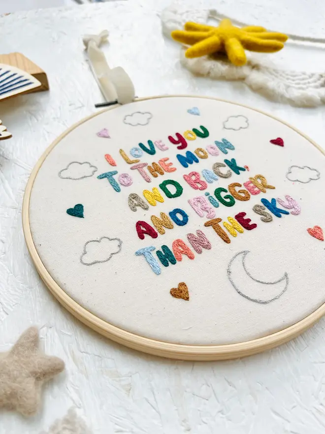 custom embroidered hoop. cotton hoop embroidered with multi coloured lettering.
