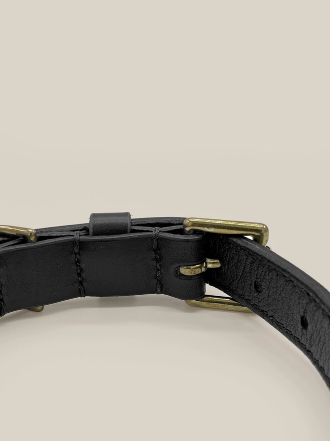 close up of stitching on black leather dog collar