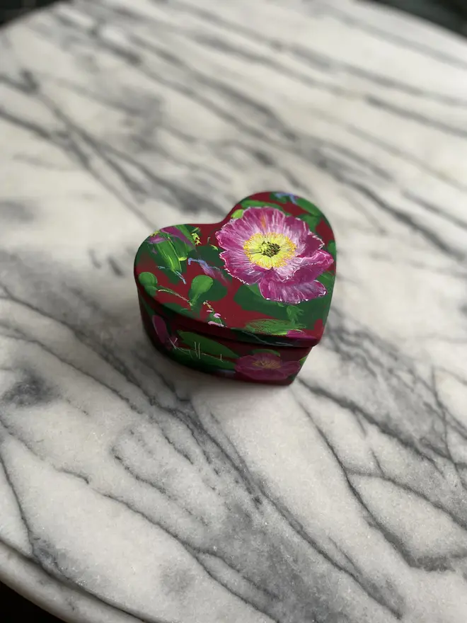 hand painted floral ceramic heart shaped keepsake box background in a deep red with pink Icelandic poppy flowers