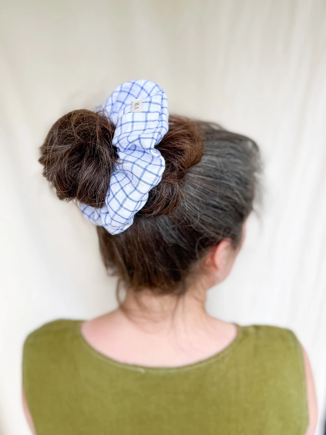 Model wearing hair tie scrunchie to show how to tie in a bun