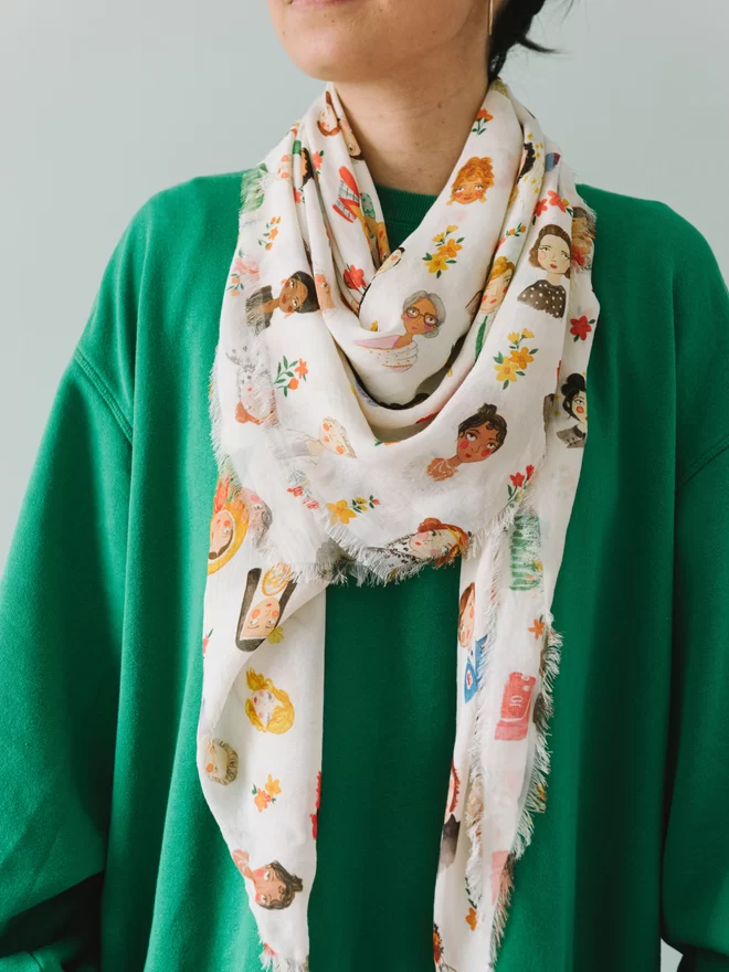 The Iconic women scarf worn with a bright green sweatshirt