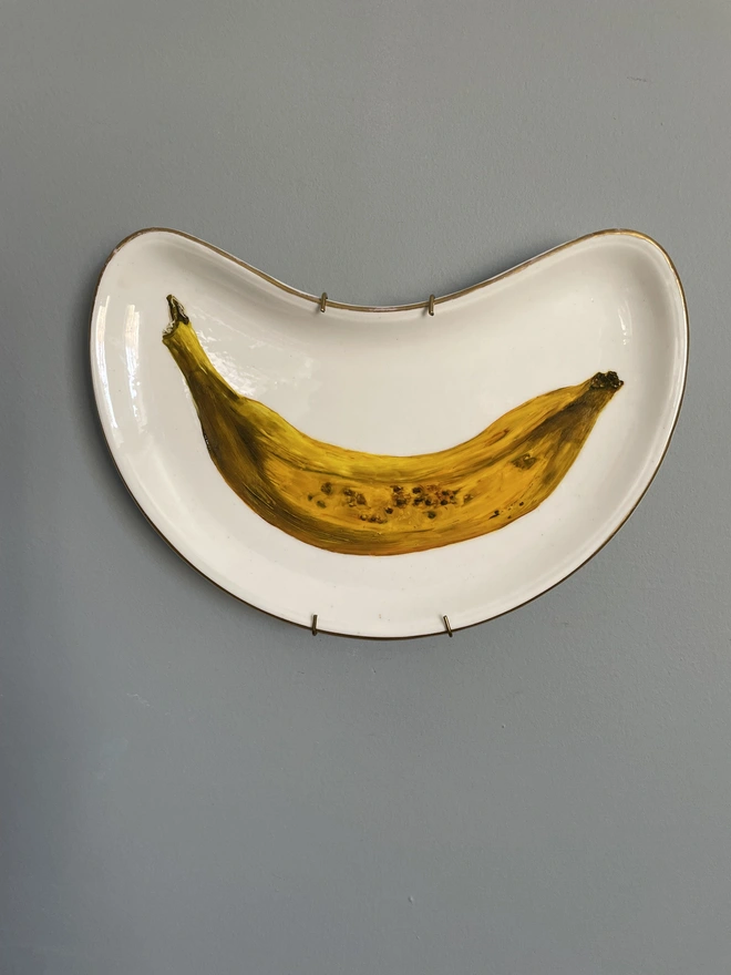 banana painting on moon plate