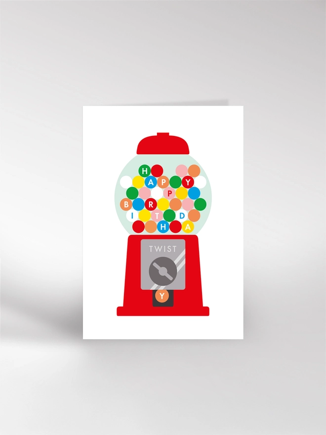 A birthday card featuring an illustration of a gum ball machine