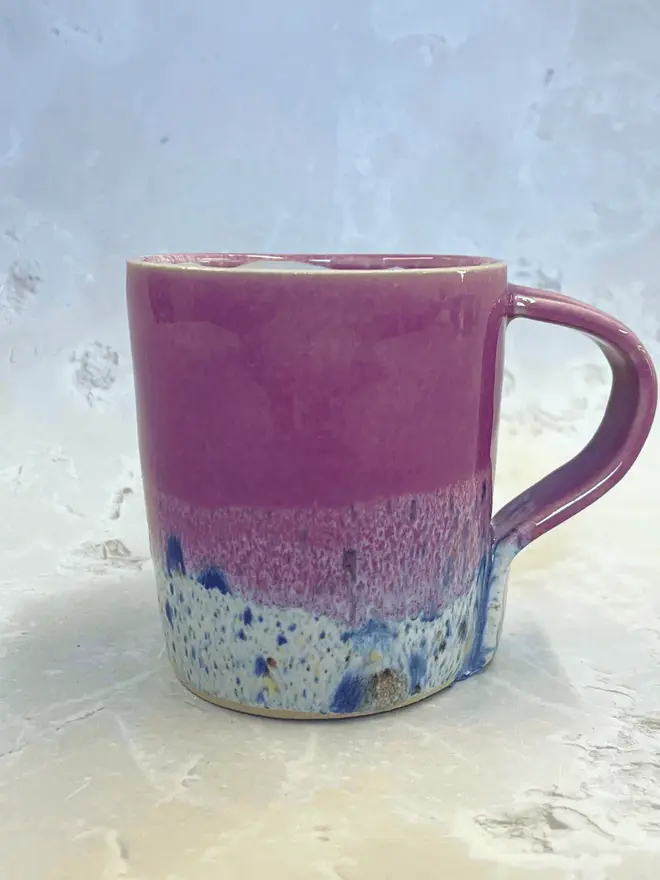 Shoreline Standard Mug, a colourful mug placed on a stone surface. 