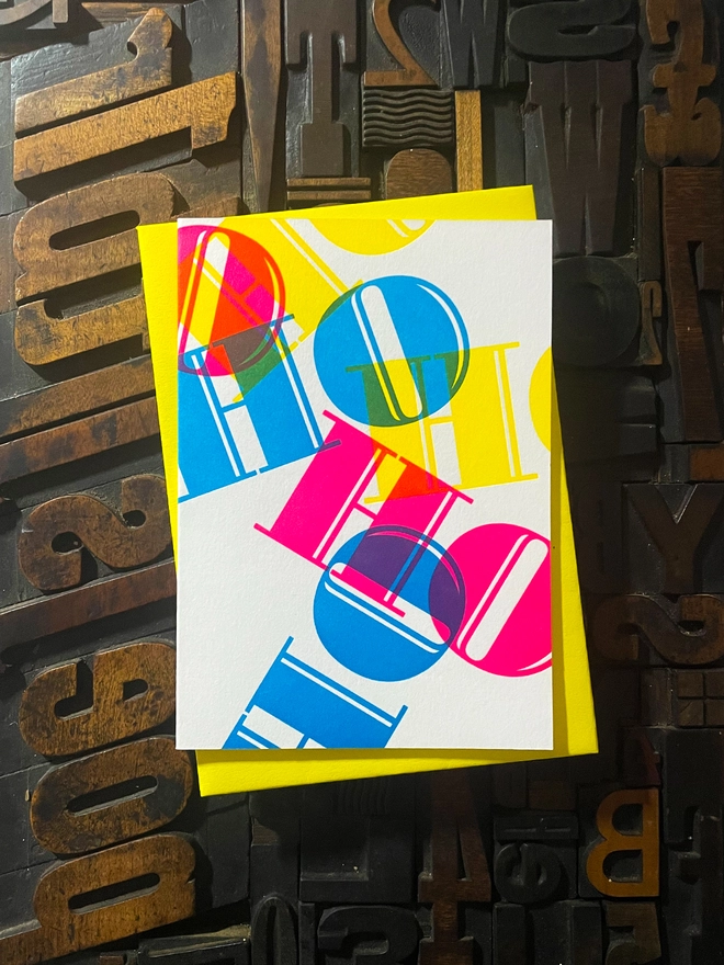 Ho Ho Ho! A beautiful typographic letterpress Christmas card. Printed with rich vibrant and fluorescent blue, magenta and yellow inks with luxury matching and contrasting envelopes; ideal to send to your designer friends at the festive season.