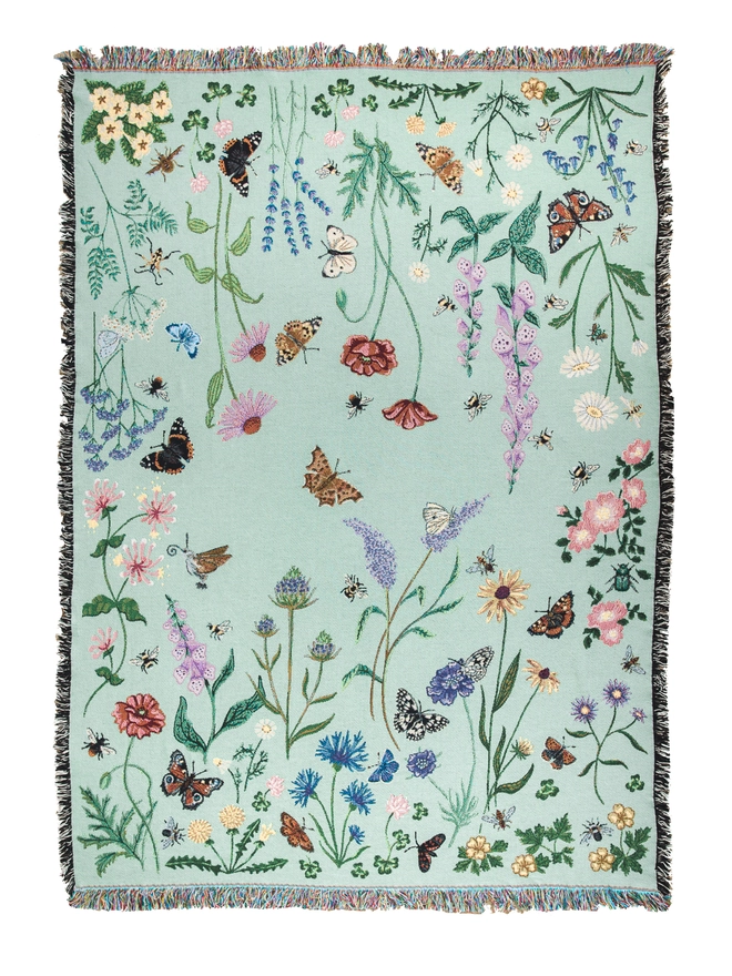 'Pollination Meadow' Recycled Cotton Blanket  by Arcana seen outside.