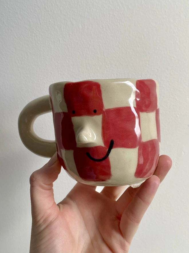red checkerboard mug angle 2