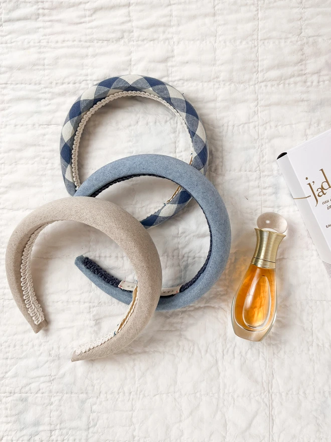 three padded headbands and a bottle of perfume