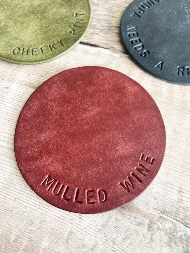 Mulberry leather coaster with mulled wine hand stamped on it, ideal Christmas gifts.