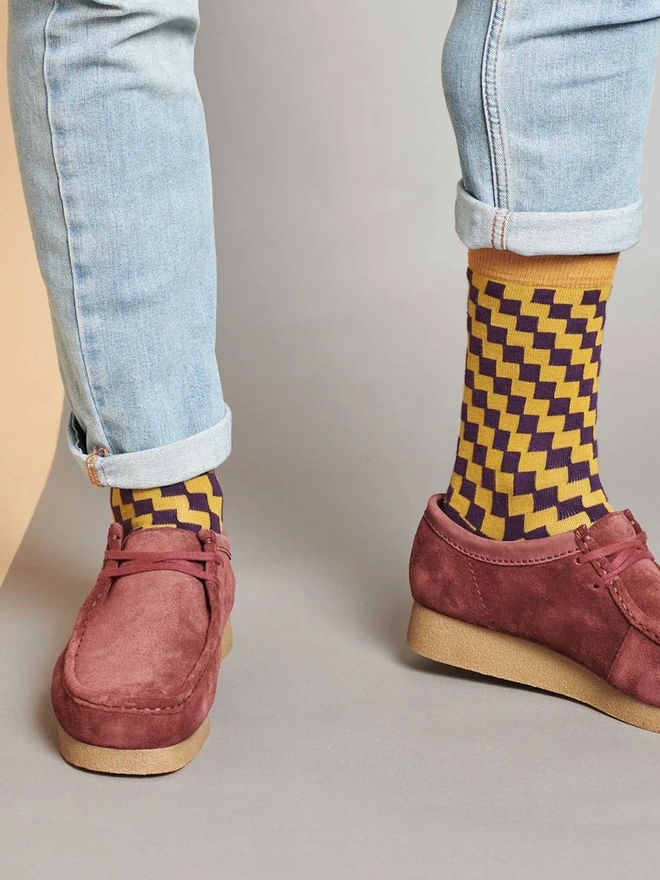 Men's Organic Cotton Ankle Socks Packs (Sets Of 3), a man wearing a pair of colourful patterned socks. 