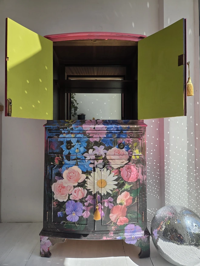 Interior of painted vintage wooden cabinet with pink, blue and floral decoration