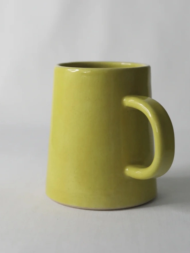Ceramic Pint Mug, a colourful ceramic mug sitting on a white surface against a plain backdrop. 