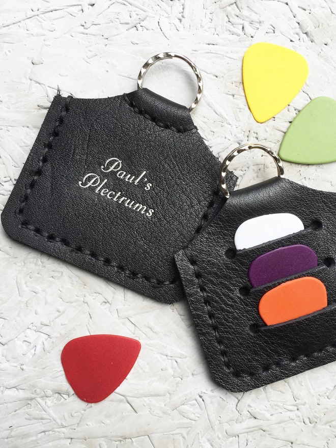 Black leather plectrum holder with script writing