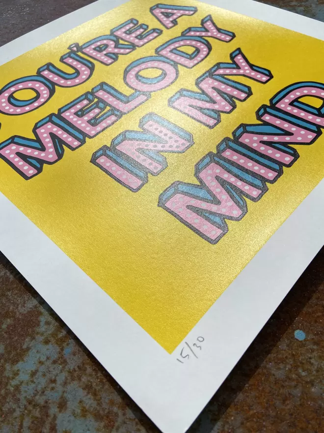 "Melody In My Mind" Hand Pulled Screen Print  square on yellow back ground with hand written letters in pink with dots printed on top that say melody of my mind 
