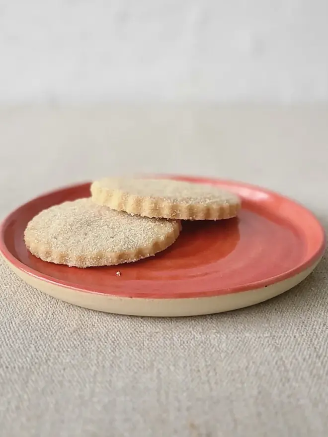 red ceramic cake plate with textured swirl design
