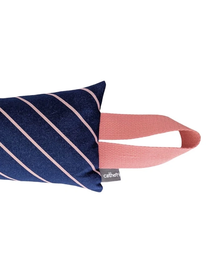 Draught Excluder, a colourful patterned draught excluder sitting on a white surface. 