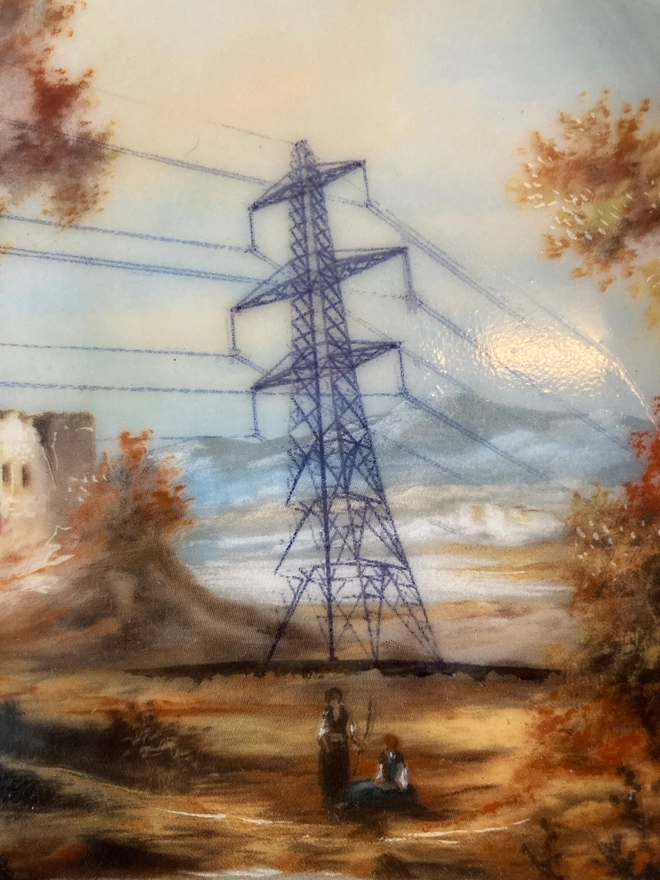 Vintage plate featuring an autumnal countryside scene with and a pylon in the center.
