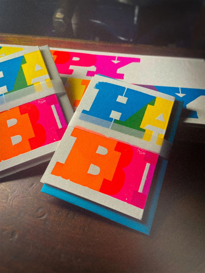 Handmade letterpress concertina birthday card featuring bold, joyful typography in vibrant neon colours. Each card is individually hand printed using traditional letterpress techniques on luxury paper stock, creating a beautifully tactile finish with deep impression and rich ink coverage. The playful fold-out concertina design reveals a striking “Happy Birthday” message across multiple panels, making it both a greeting card and a keepsake.  Created by hand for Holly & Co , this contemporary artisan birthday card combines modern graphic design with traditional craftsmanship. Perfect for design lovers, colourful stationery enthusiasts, and anyone looking for a unique luxury birthday card with personality.