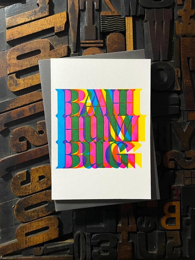 Bah Humbug! A beautiful typographic letterpress Christmas card set. Printed with rich vibrant and fluorescent blue, magenta and yellow inks with luxury matching and contrasting envelopes; ideal to send to your designer friends.