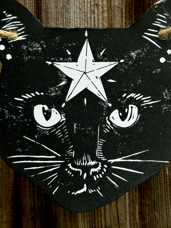 Black Cat & Stars Garland.7 Hand Printed components in black ink. Close up of Cats Face which has a star on its forehead.