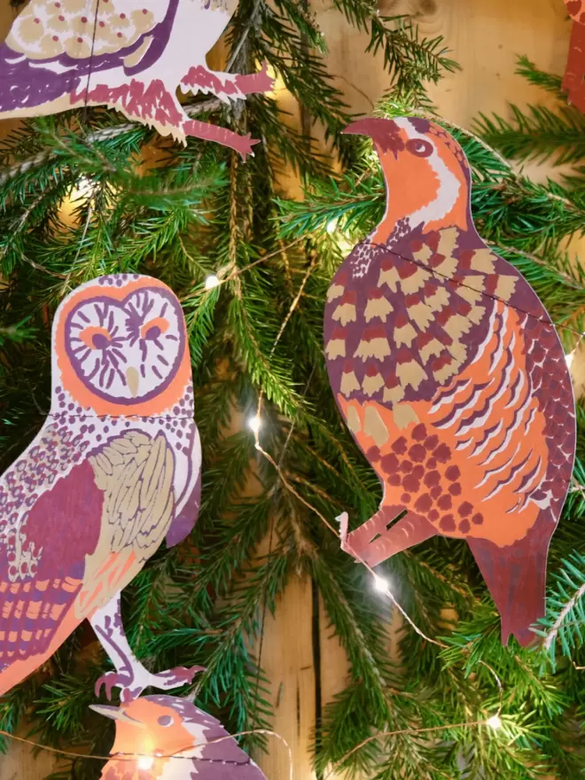 Close up of the autumn colour birds hanging on Christmas tree