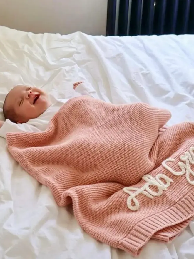 Hand-embroidered pink baby blanket