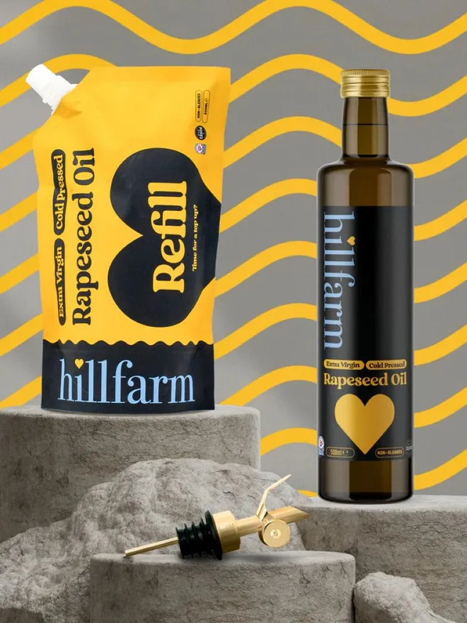 yellow pouch of rapeseed oil next to pourer spout  and glass bottle