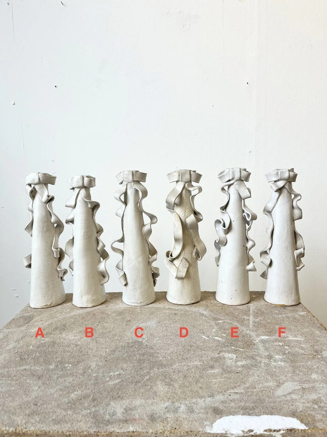 Six candleholders in line