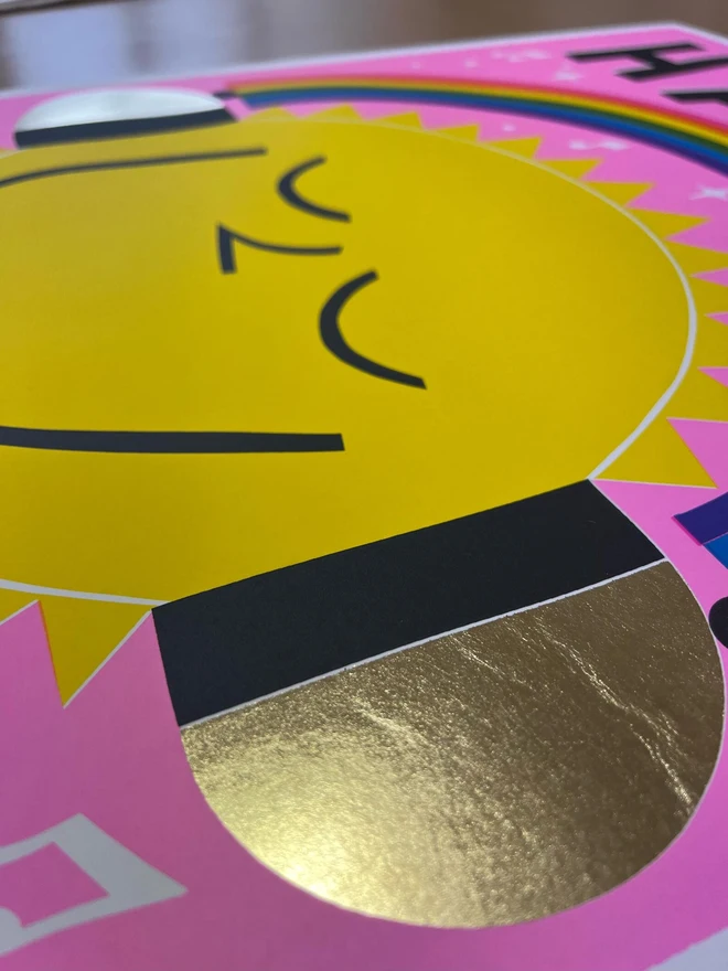 'Happy Place' Screenprint, a colourful screenprint. The print says 'Happy place' and shows an image of a sun under a rainbow. 