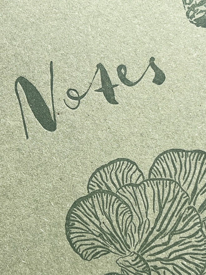 Close up of the word 'notes' on the front of the notebook.