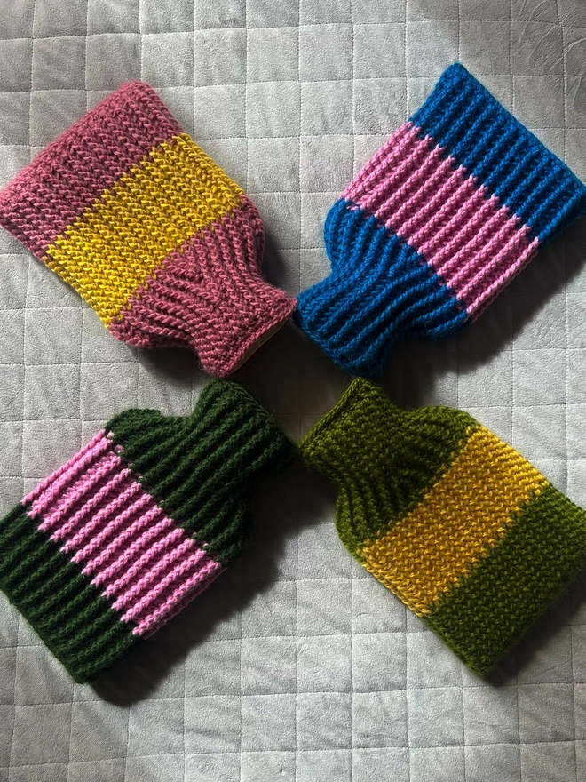 Four hot water bottles, one showing the opening at the back with vintage yellow buttons