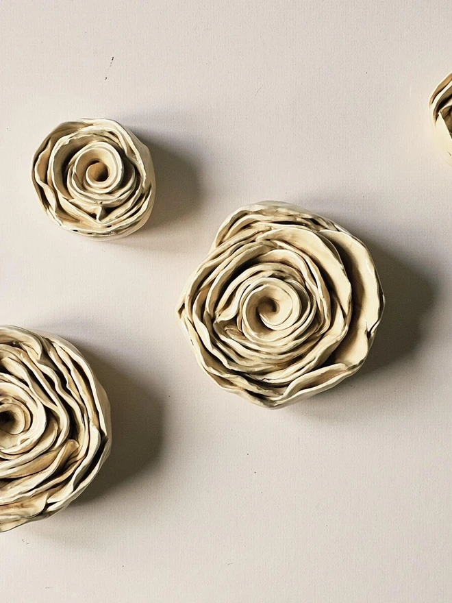 Cream handmade ceramic rose sculpture with a glossy glaze, crafted in 3D and designed to hang on a wall