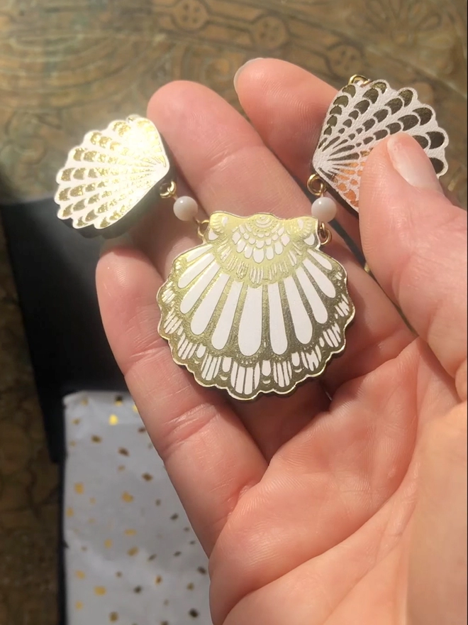 white leather seashell necklace in hand