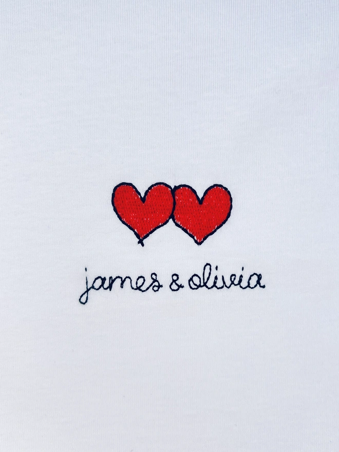     White T-shirt embroidered with red heart motif and couples personalised lettering 