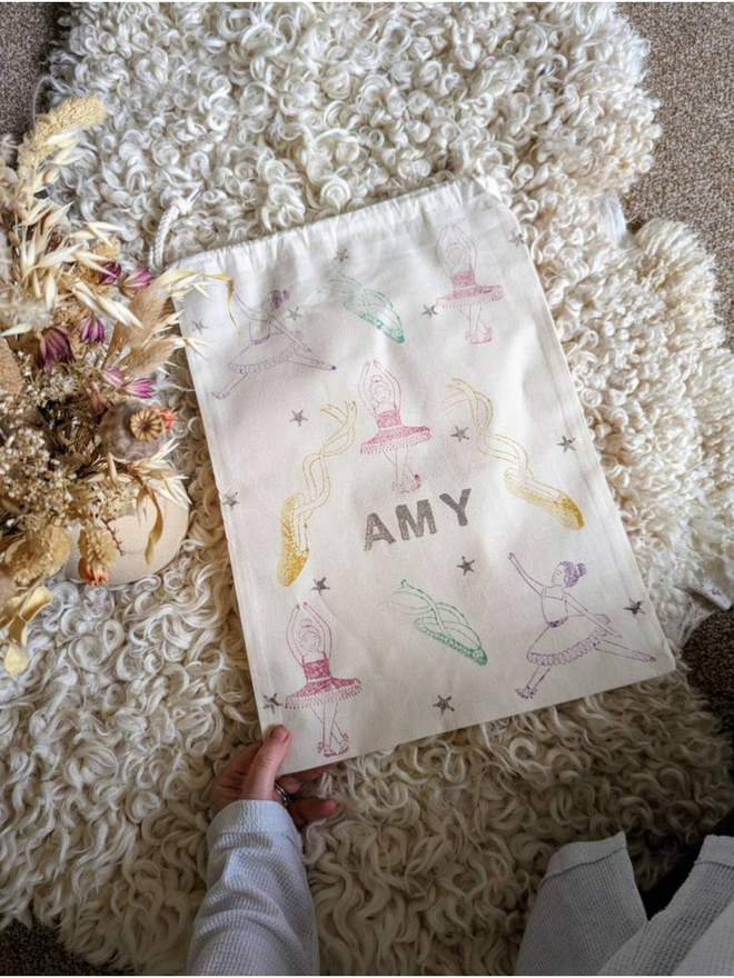 personalised ballet bag. a drawstring ballet bag with a personalised name and printed ballerina.