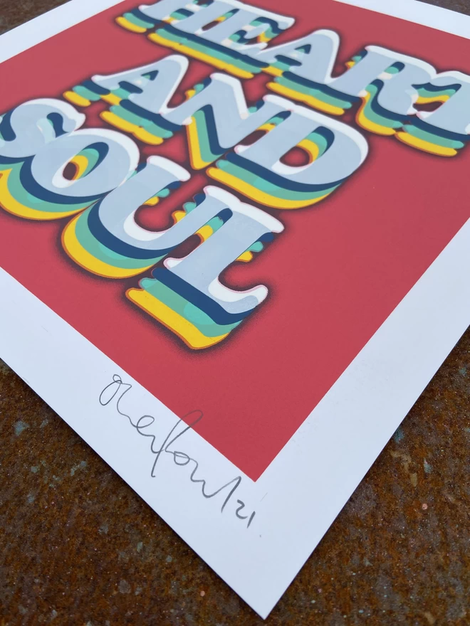 "Heart & Soul" Hand Pulled Screen Print on a red background with rainbow printed typography that says heart and soul 