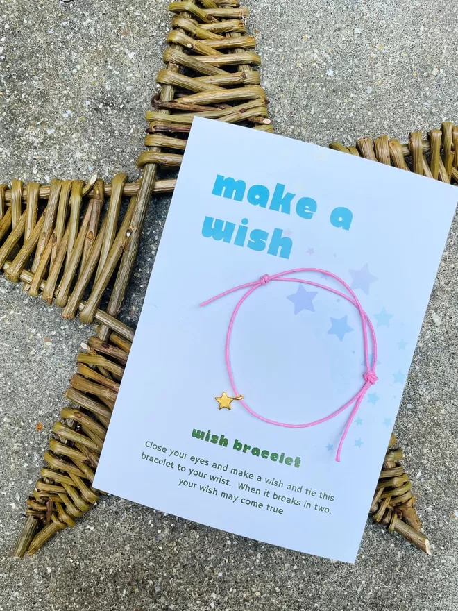 Make a wish bracelet on it's gift card on a rattan star.