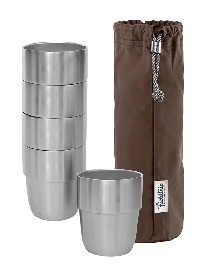 'expedition' stainless steel stacking cups set. a stacked set of stainless steel cups, photographed next to an olive drawstring bag.