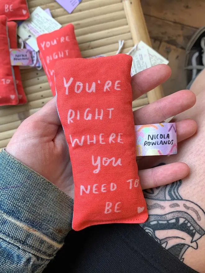 Red sensory palm bag says 'you're right where you need to be'