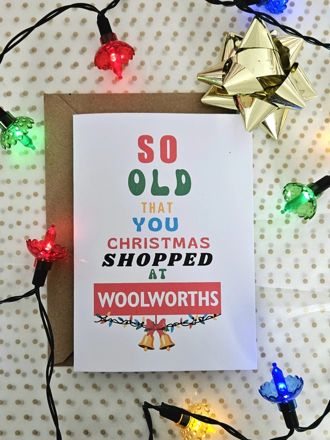 Card that says so old you Christmas shopped at Woolworths with retro fairy lights around it