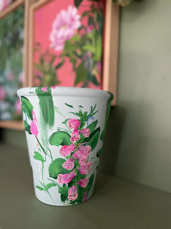 hand painted terracotta floral fox glove plant pot background in a light mint with pink fox glove flowers