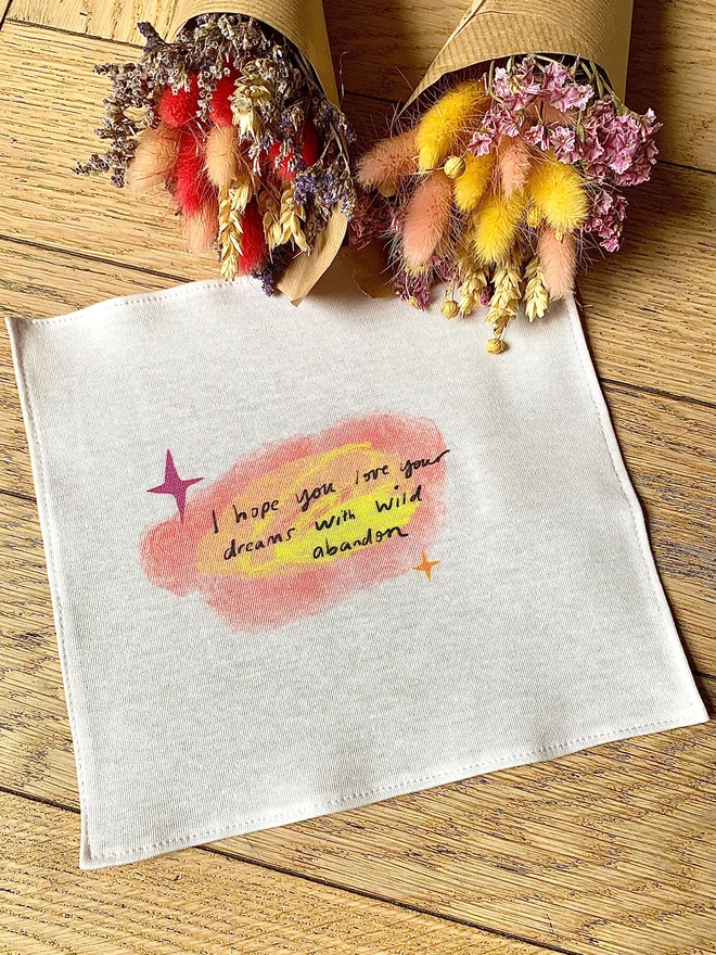 Organic cotton reusable hanky reads 'I hope you love your dreams with wild abandon'