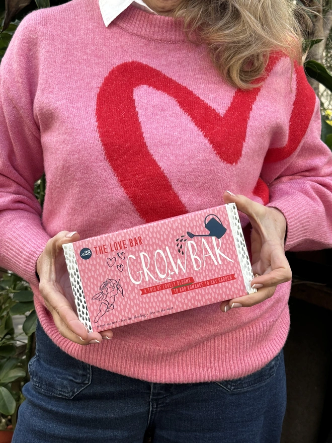 The Love Growbar against a gorgeous pink backdrop with a love heart