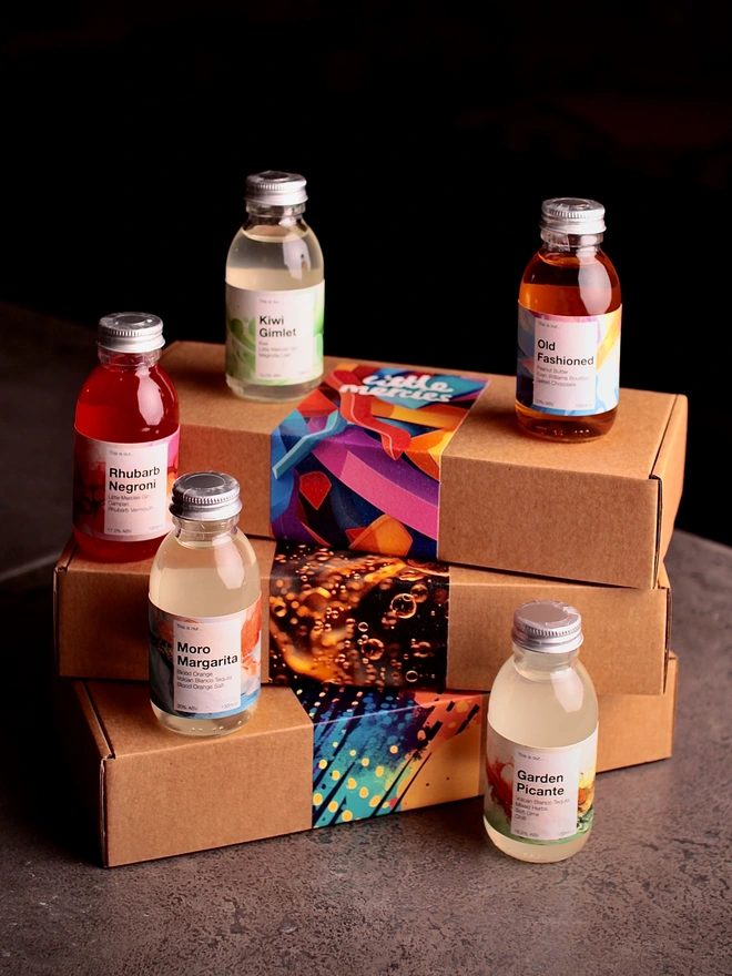 Picture of a 5 bottle gift box, showing all 5 100ml bottles and some of the varied labels for the box