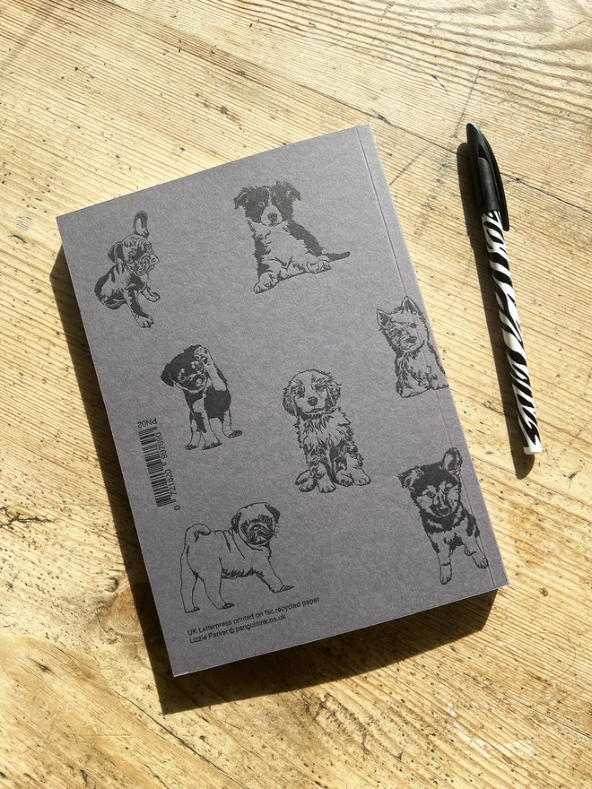 Back of note book showing multiple puppies.