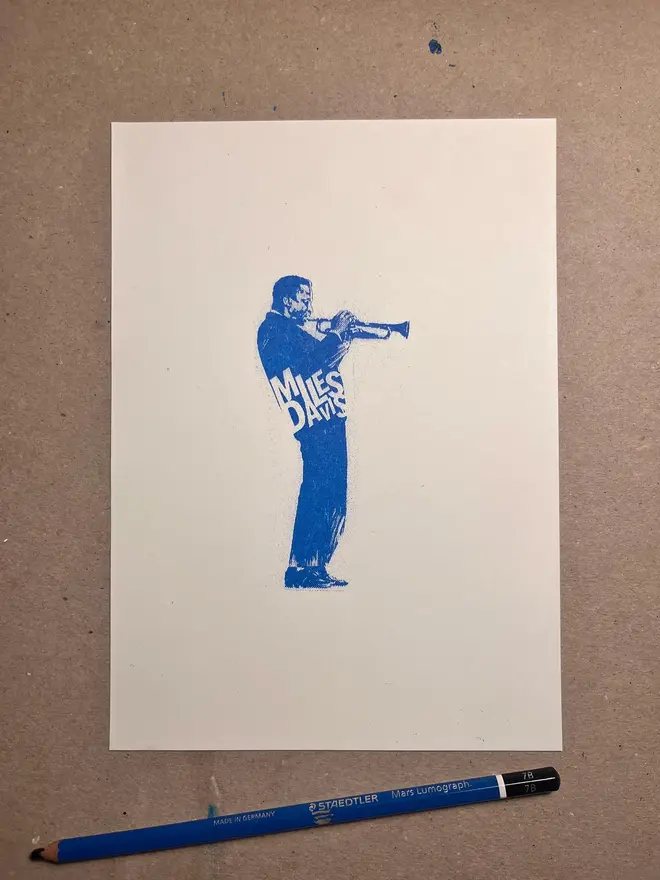 Miles Davis Risograph Print, on a wooden table. 